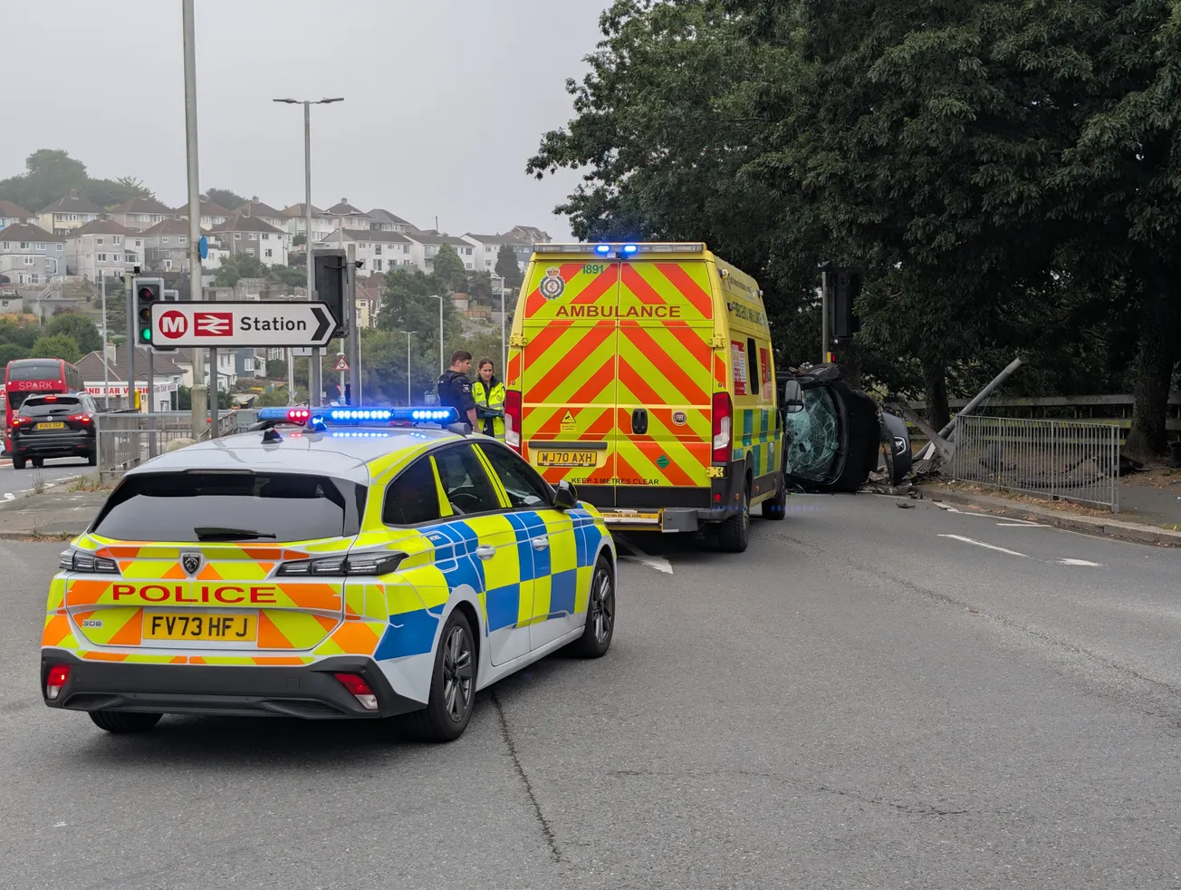 Serious crash shuts Plymouth road as car flips on its side and takes out pole